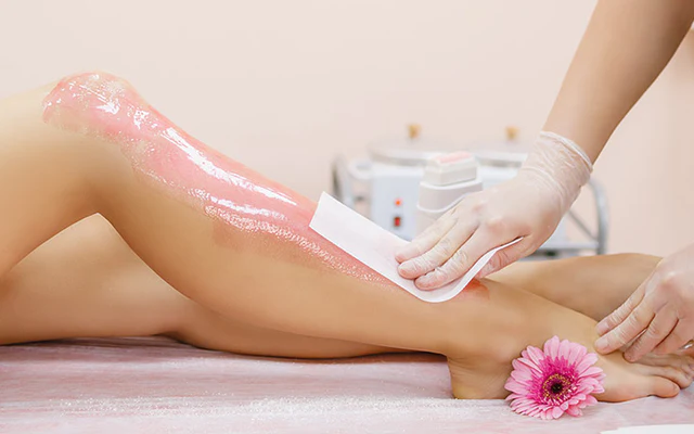 Applying wax to a young woman_s leg for hair removal_1024x400